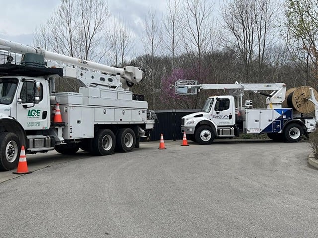 LG&E and Spectrum trucks used to lay fiber optic cables for residents in Jefferson County.