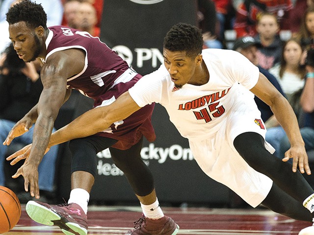 Louisville's Donovan Mitchell fights for a loose ball with Eastern Kentucky guard Asante Gist.