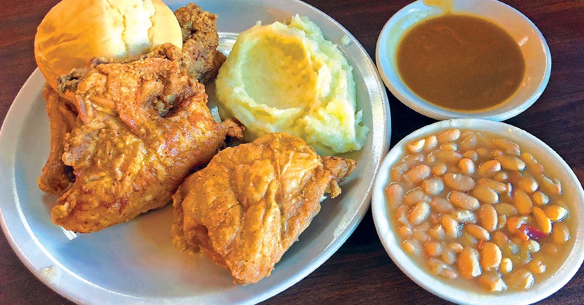 Cottage Inn&#146;s iconic fried chicken, with mashed potatoes and gravy and a side of white beans.