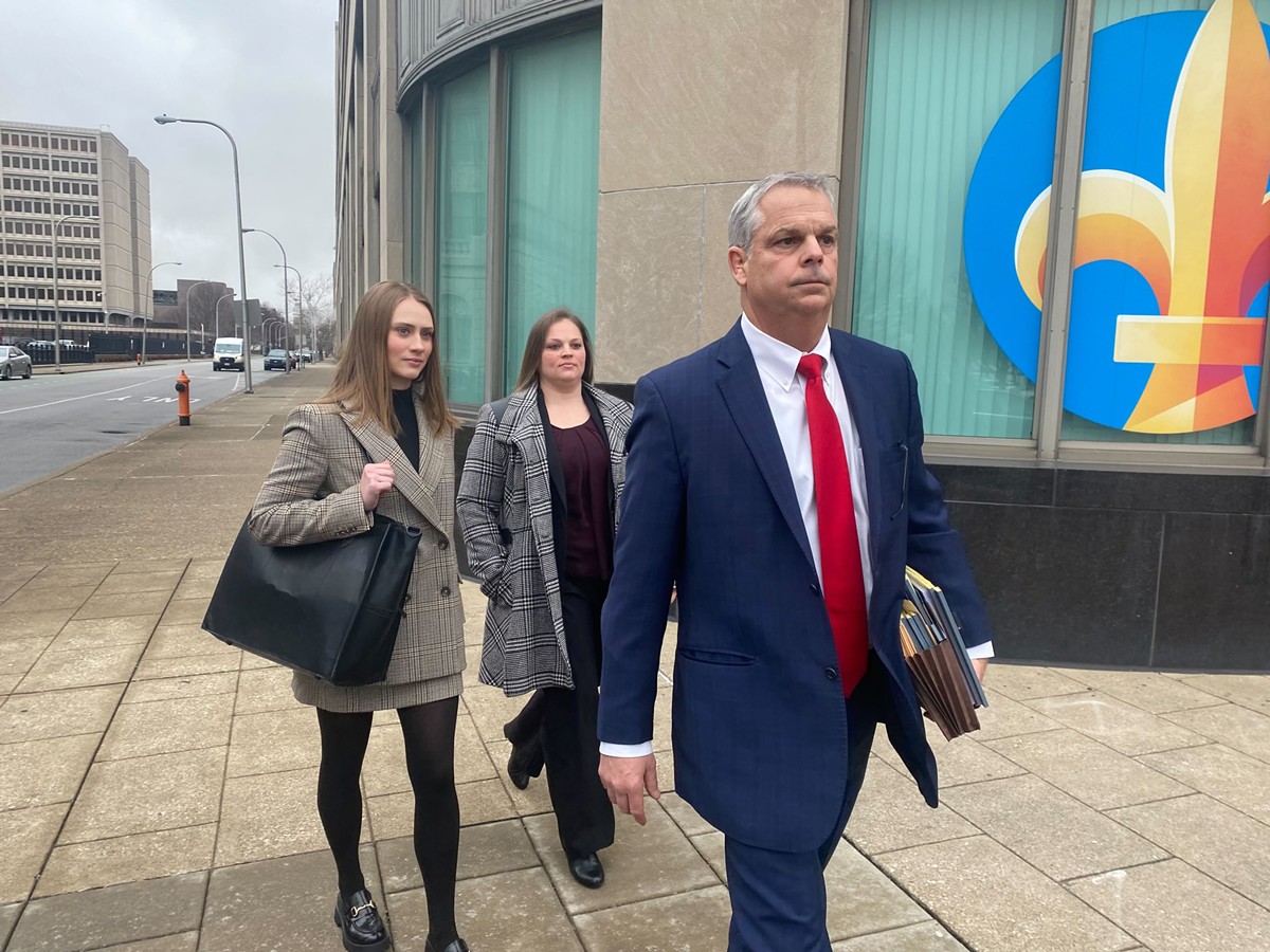 Katie Crews, center, and her lawyer, Steve Schroering, right, depart downtown Louisville's federal courthouse on Monday afternoon.