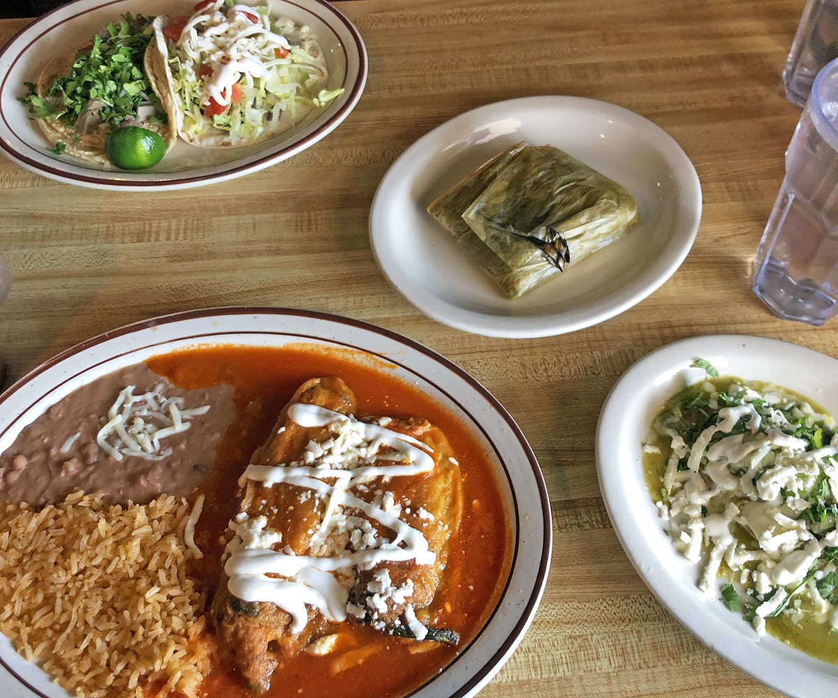 A hearty lunch at La Lupita in Clarksville. where the menu is in Spanish and English: Clockwise from upper left, lengua and asada tacos, a Oaxaca-style tamale, an Oaxacan Tlacoyo, and a chiles rellenos plate.