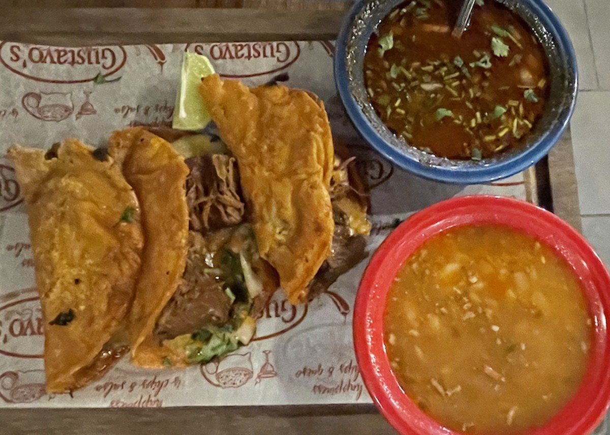 Birria is like a turbo-powered taco. Gustavo's tasty version is made with long-marinated and simmered Angus beef, chiles, and spices packed into marinated and fried corn tortillas to maximize its flavor.