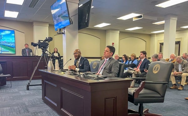 Corrie Shull, the chairman of the JCPS Board of Education, left, speaks as Superintendent Marty Pollio listens during a Kentucky House Education Committee meeting at the Capitol in Frankfort, March 5, 2024.