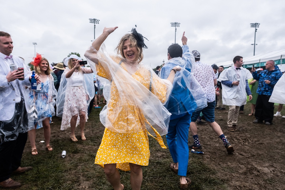Despite the rain and mud, a group of friends dance in the infield at Churchill Downs on Derby Day, 2019.