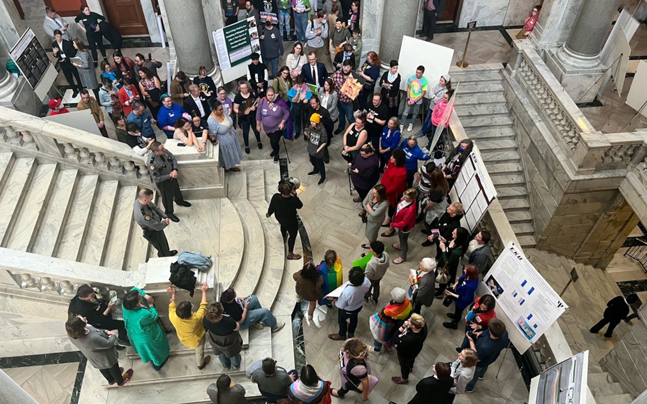Protesters rally at the foot of the House steps as state representatives debate House Bill 470.