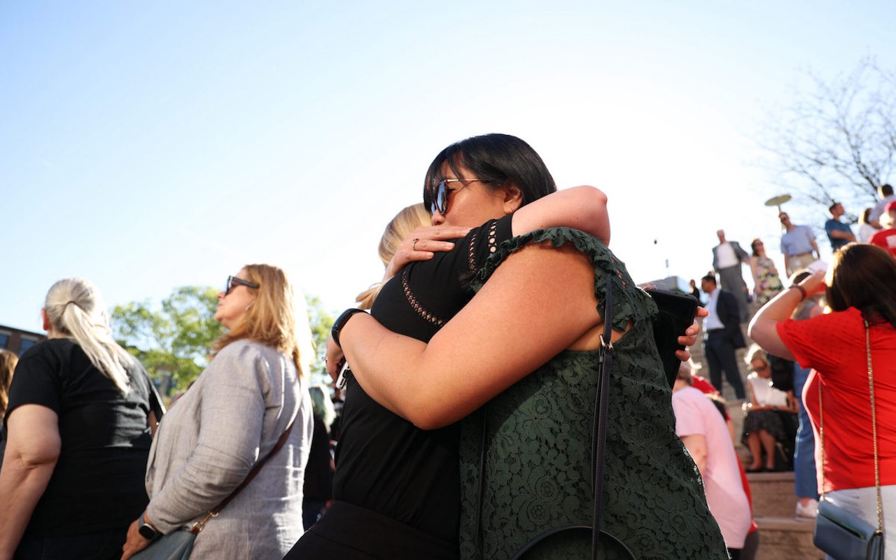 People hug at the community vigil honoring the victims of the Louisville mass shooting on Wednesday, April 12, 2023, at the Muhammad Ali Center plaza in Louisville, Kentucky. Kentucky Lantern photo by Abbey Cutrer