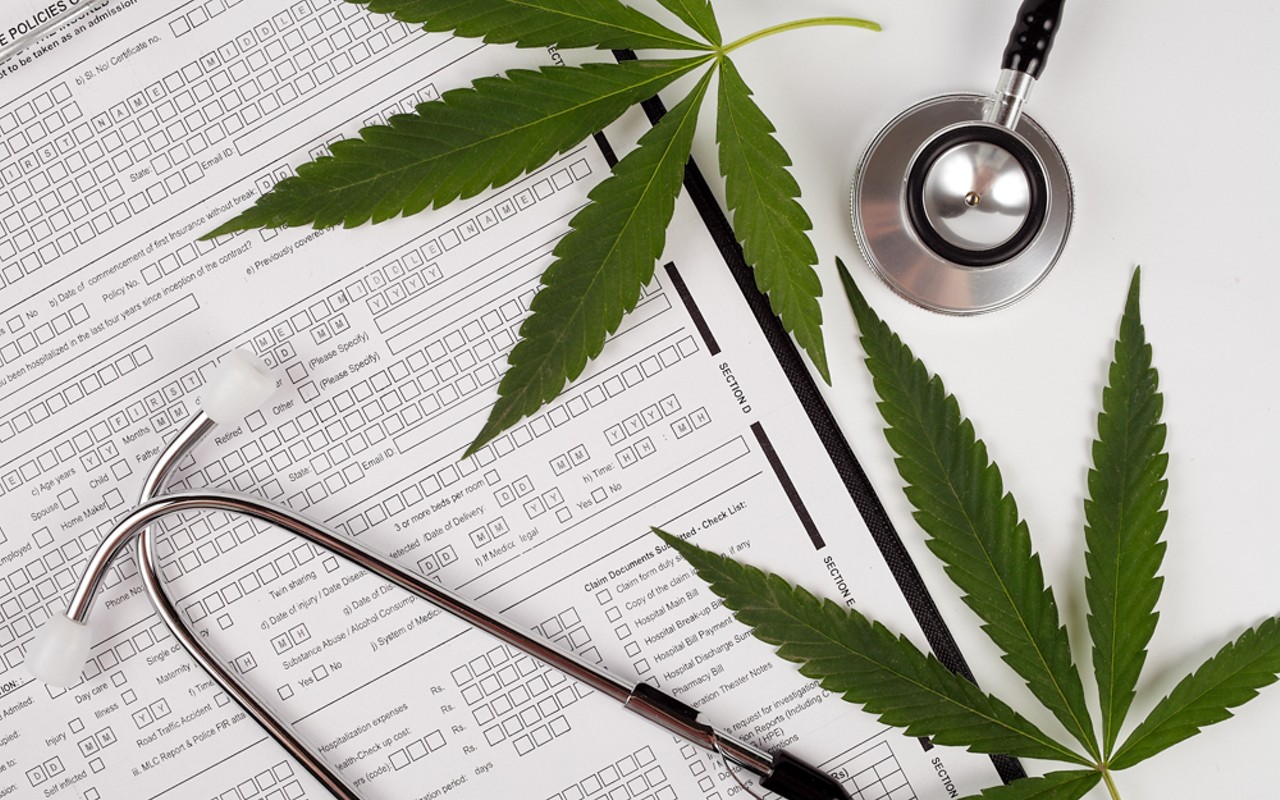 Cannabis leaf, medical phonendoscope on a white background