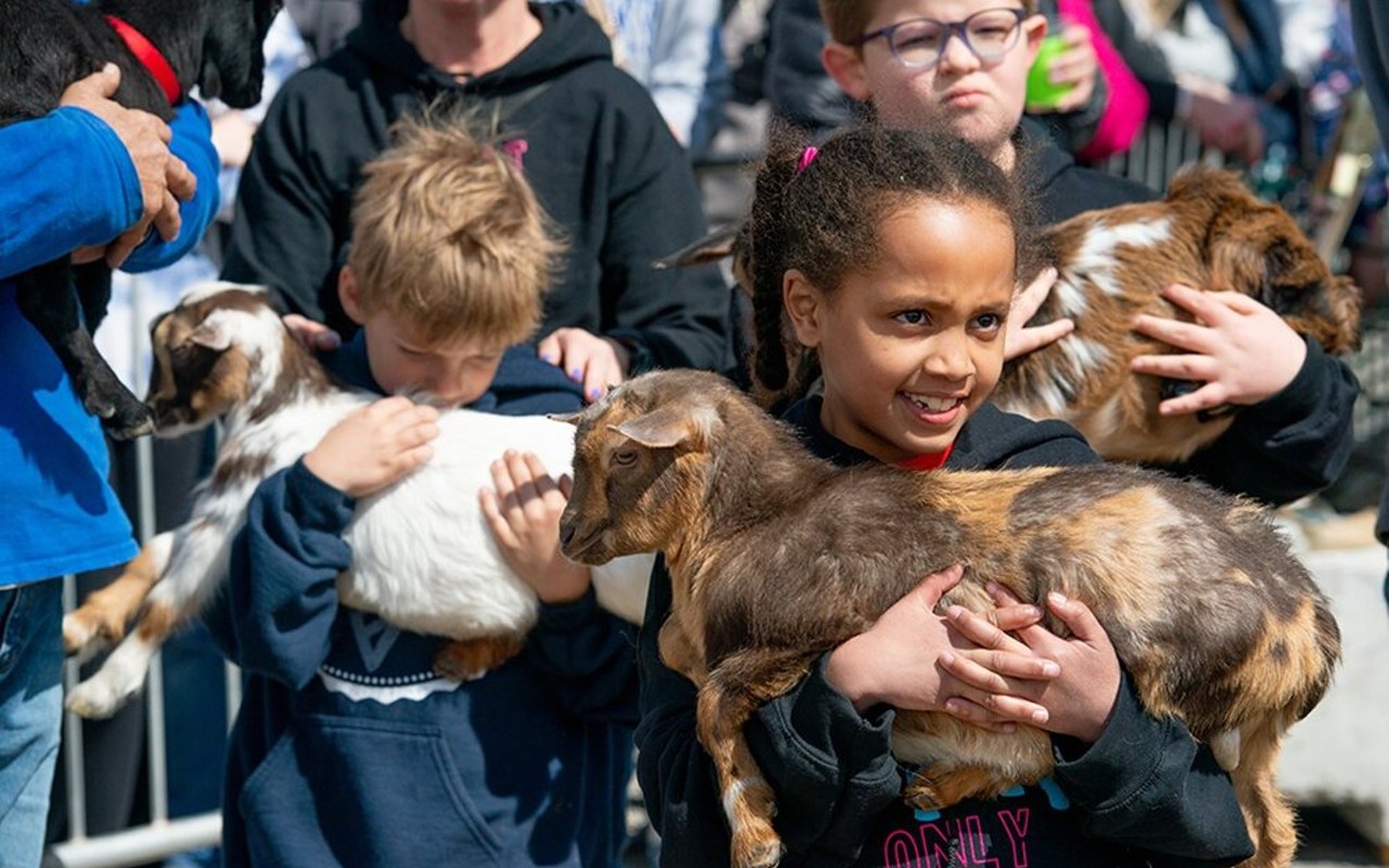Kids hold baby goats at Nulu's Bock and Wurst Fest.