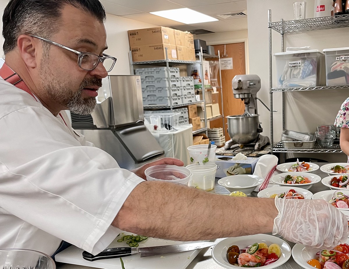 Chef Anthony Lamas plates a dozen bowls of shrimp seviche, his Highlands restaurant's namesake dish.