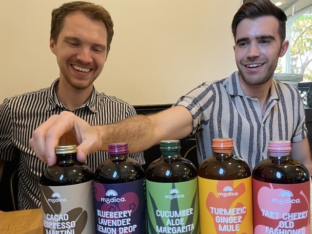 A drink made with Pride: J.D. Mitchell (left) and Eric Wentworth, co-owners of Modica, billed as a 100% certified gay-owned local company that produces M?dica, billed as "the world's first superfood cocktail and mocktail mixer."