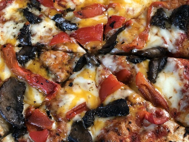 MozzaPi&#146;s cheese pizza with roasted red peppers and mushrooms.