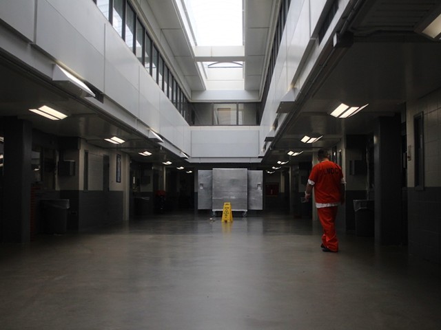 An incarcerated person walks through a section of Louisville’s jail.