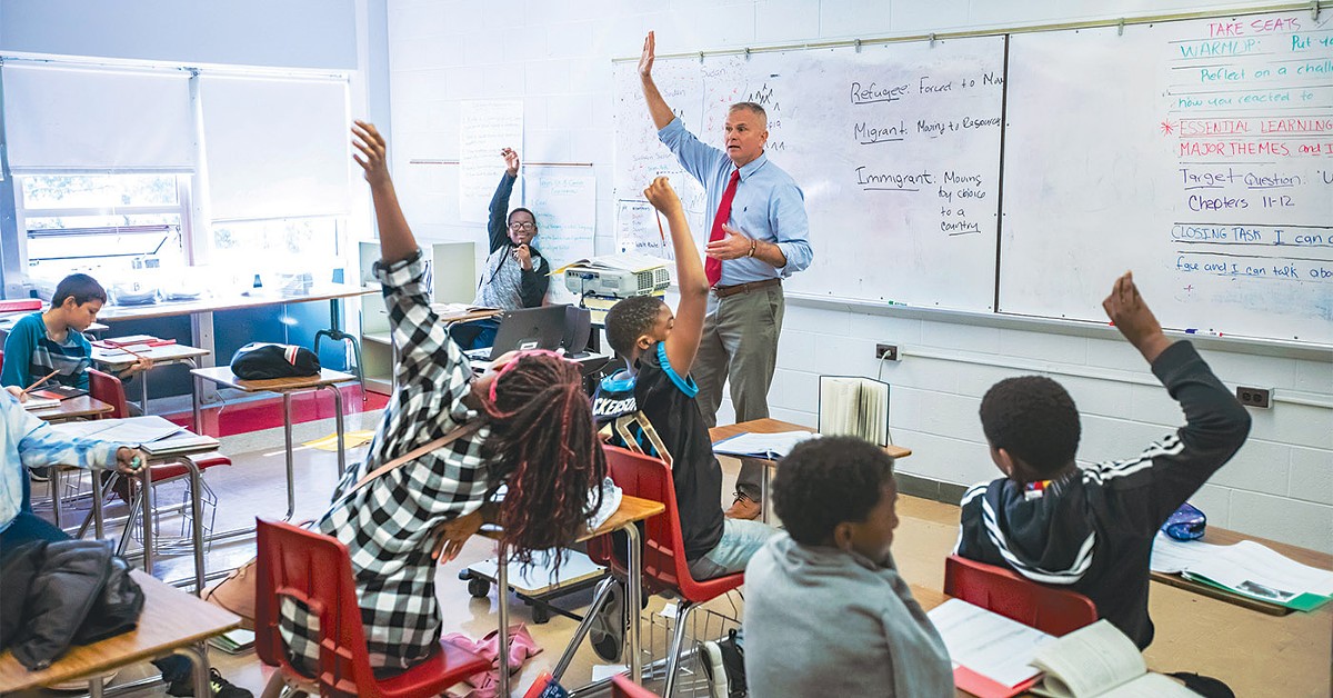 Fred Johnson and his sixth-grade social studies class discuss 'A long Walk to Water,' a book about the 'Lost Boys' of Sudan.  |  Photos by Kathryn Harrington