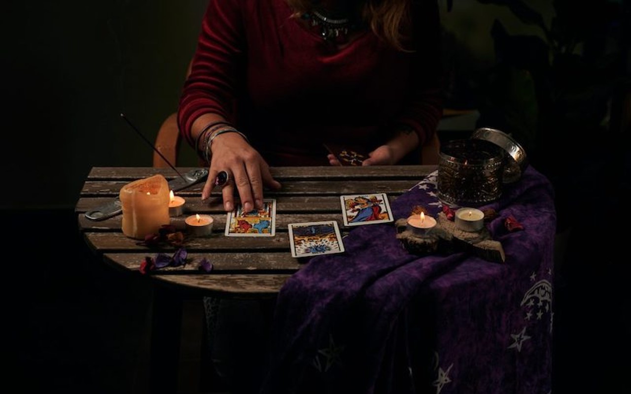 Tarot cards on a table with candles.