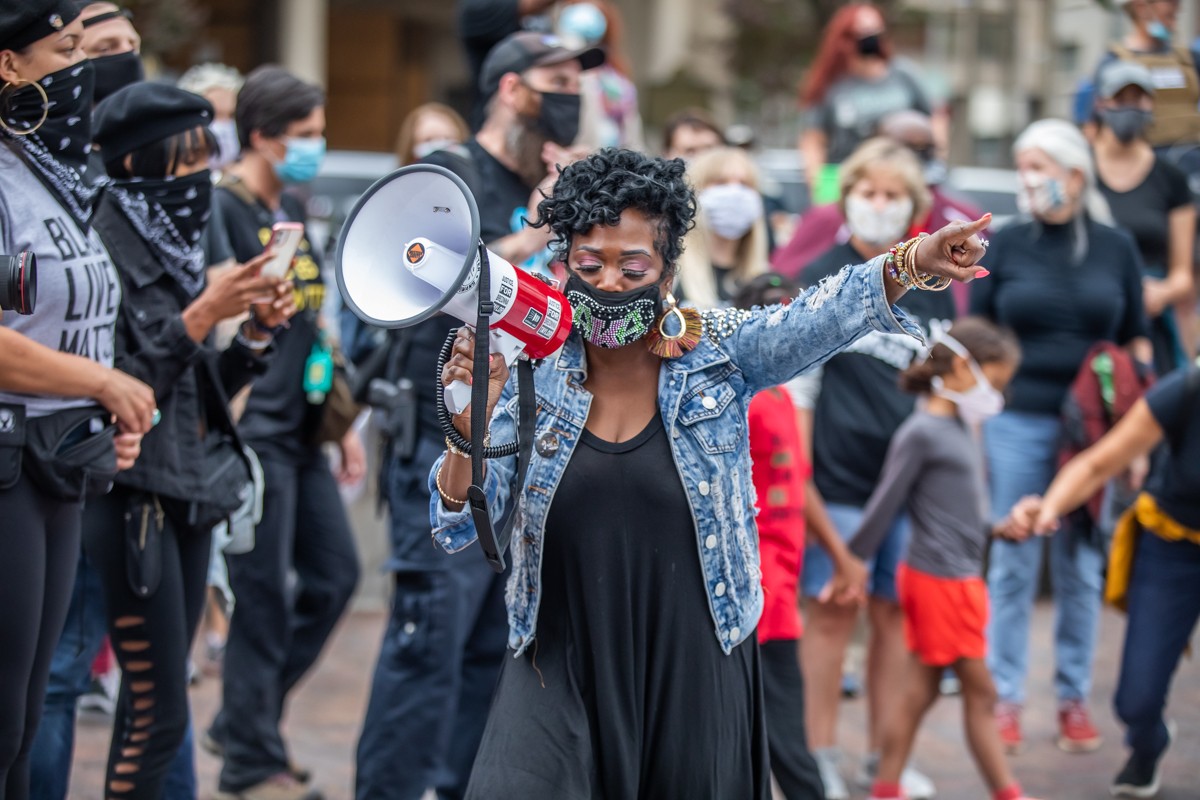 A protester led chants around the memorial for Breonna Taylor as hundreds of protesters gathered in Jefferson Square Park.