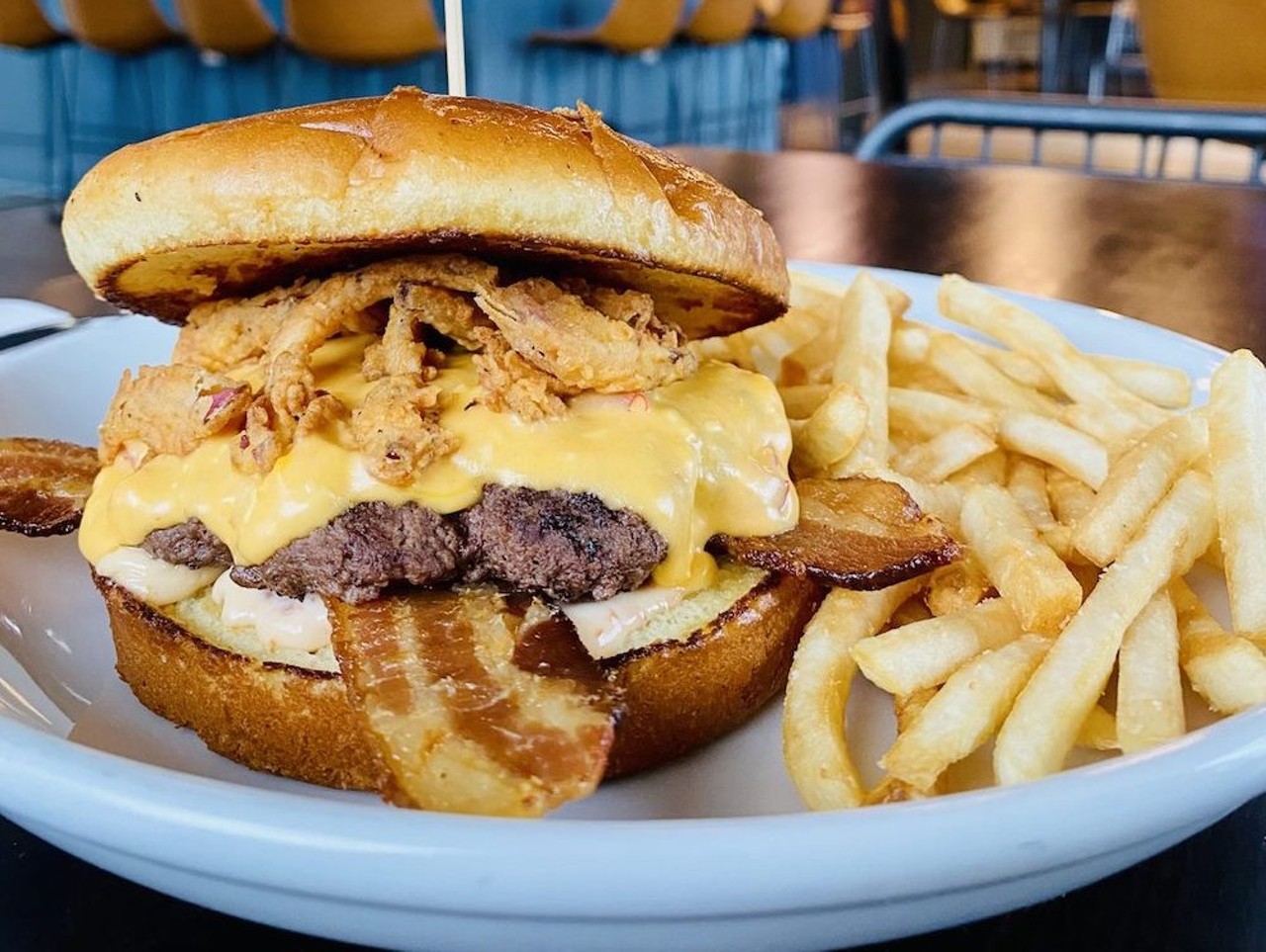Cask Southern Kitchen & Bar
Just In Queso
Made with 1/3 pound smash burger, applewood smoked bacon, house-made pimento cheese queso, tomato, mayo, cask pickles, and crispy onions.