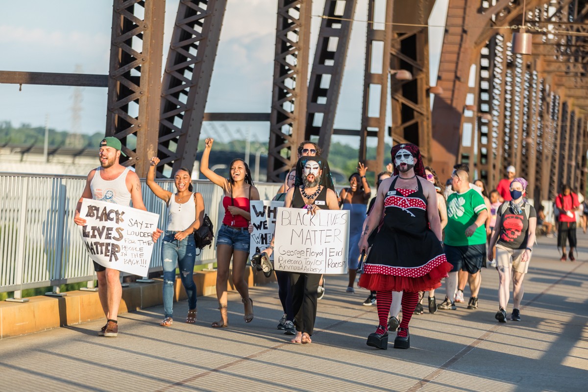 The Derby City Sisters and others walked to the middle of the Big Four Bridge to hold a vigil for Black people killed and brutalized by police.