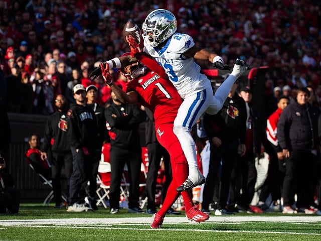 UK defensive back Andru Phillips intercepts a pass to UofL wide receiver Jamari Thrash during the Governor's Cup game at L&N Federal Credit Union Stadium on Nov. 25, 2023.