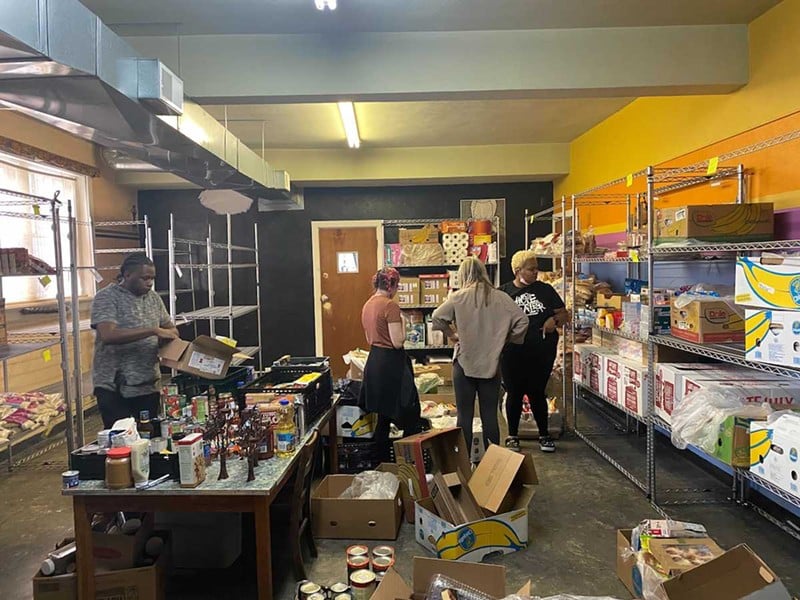 Hope Buss staff and volunteers organize donations in a food pantry in the basement of the West End church the nonprofit is headquartered out of.  |  Photo by Josh Wood. - Josh Wood