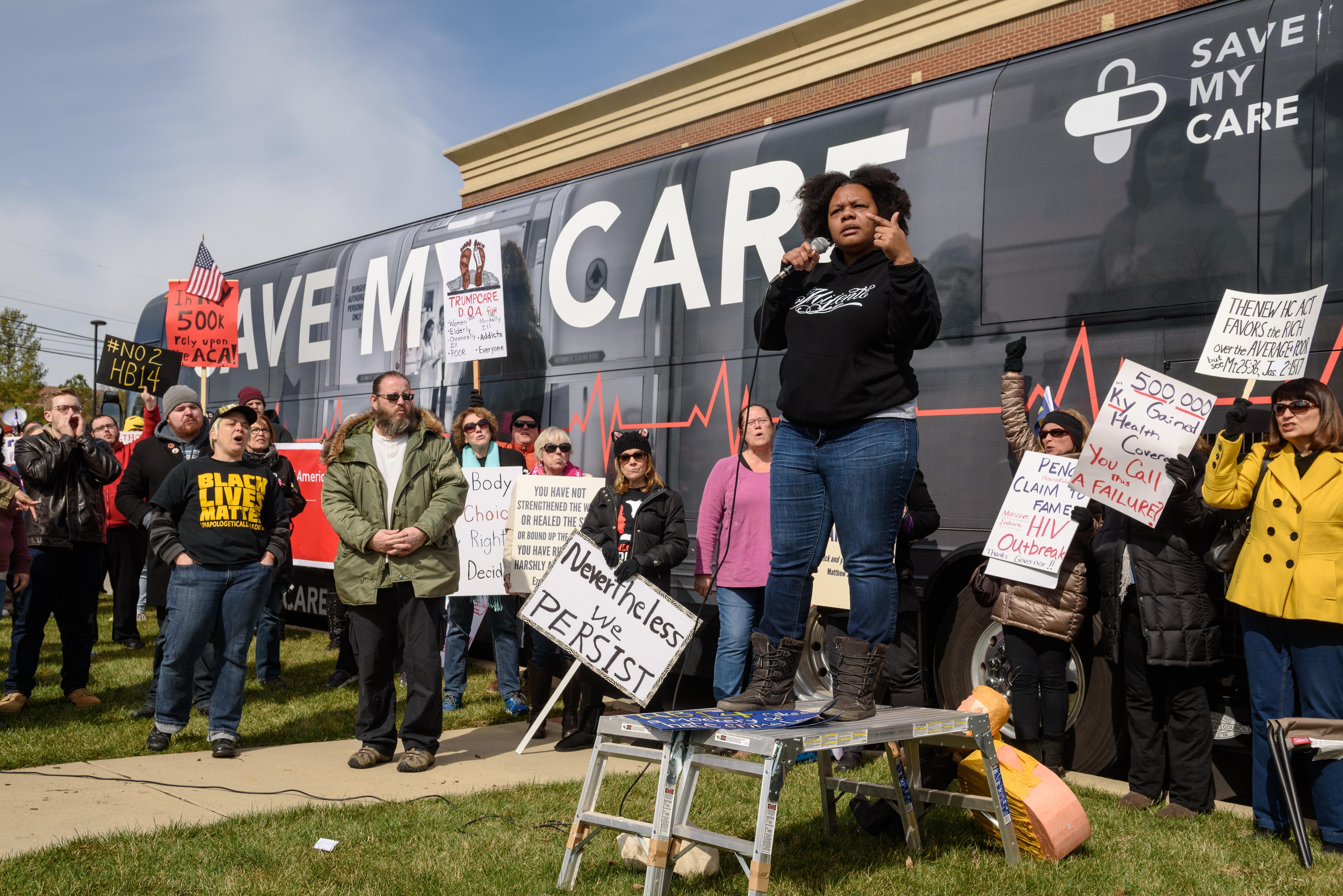 Chanelle Helm, a Black Lives Matter of Louisville organizer, delivers her message to protesters gathered in front of Indivisible Kentucky's Save My Care Bus. - BRIAN BOHANNON