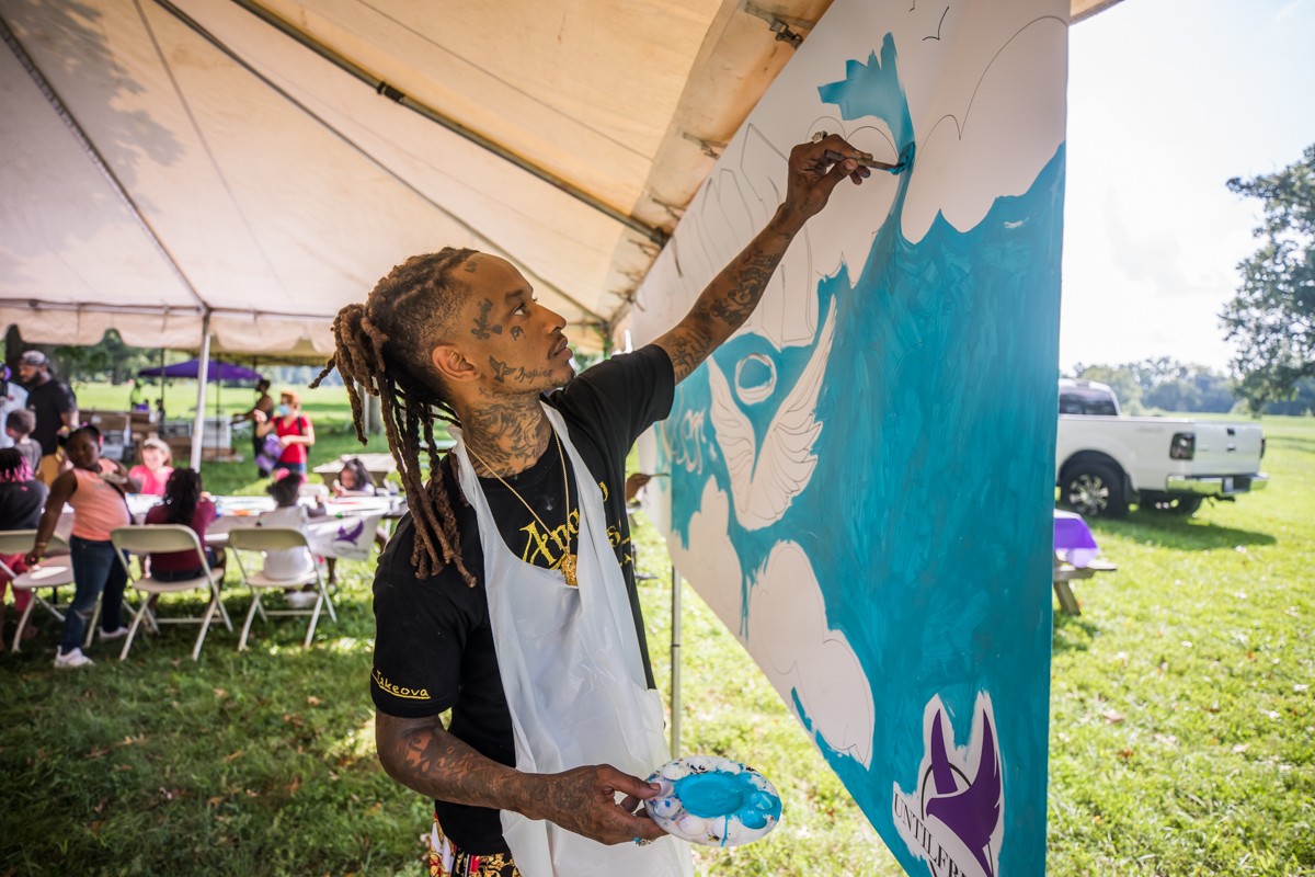 Local artist Angelo Picasso worked on a piece honoring Breonna Taylor at Bre-B-Q on Sunday. - KATHRYN HARRINGTON