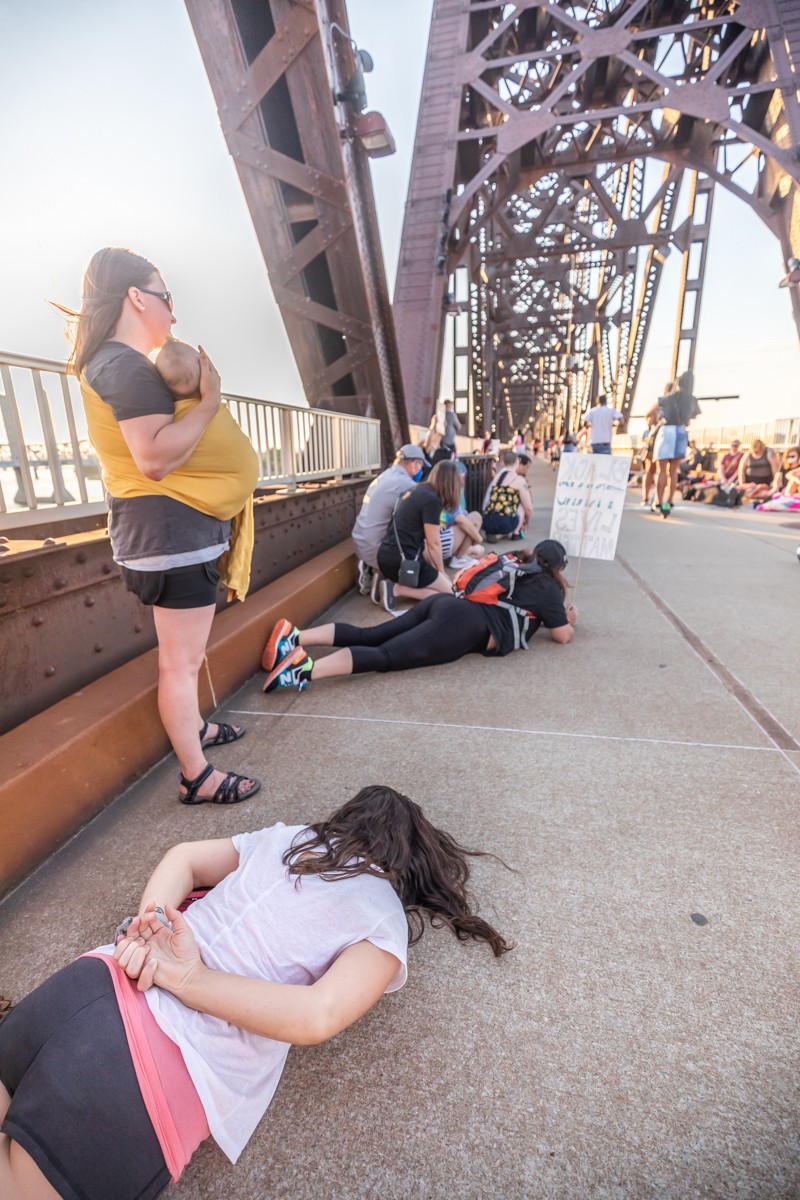 Many participants placed their hands behind their back and lay on the ground to symbolize how George Floyd was handcuffed while a white police officer knelt on his neck for 8 minutes and 46 seconds. - KATHRYN HARRINGTON