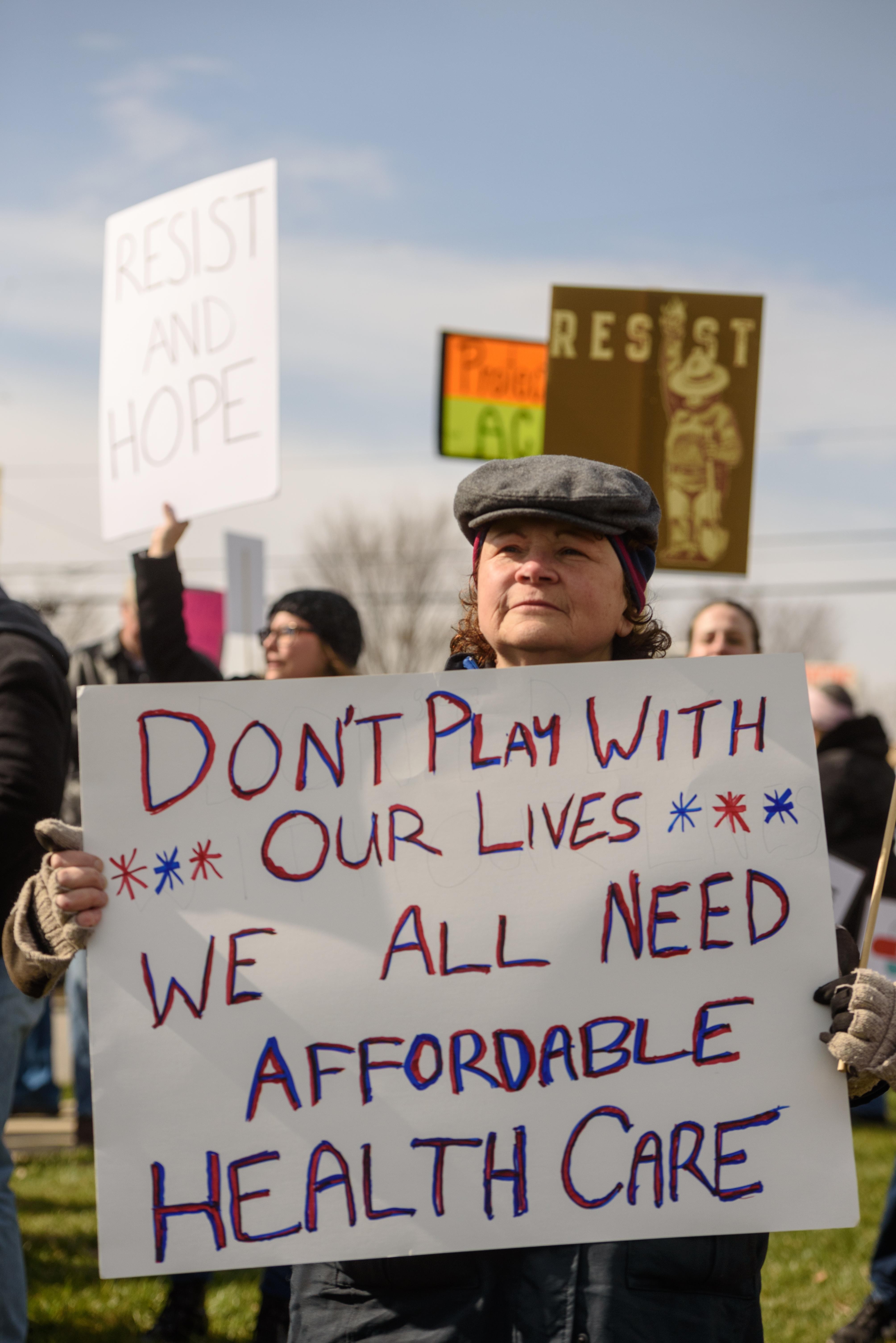 Holding a sign that read, "Don't play with our lives - We all need affordable healthcare," Melinda Feldman said, "I'm here because I'm an American and I care about healthcare, and not just for myself." - BRIAN BOHANNON