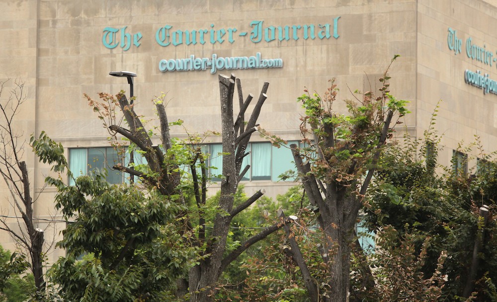 The Courier Journal legally lopped off the tops of the trees to clear views for security cameras.