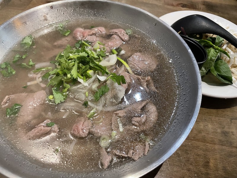 A generous portion of paper-thin beef, noodles, cilantro and onion boosted a rather light broth in a big bowl of beef pho.