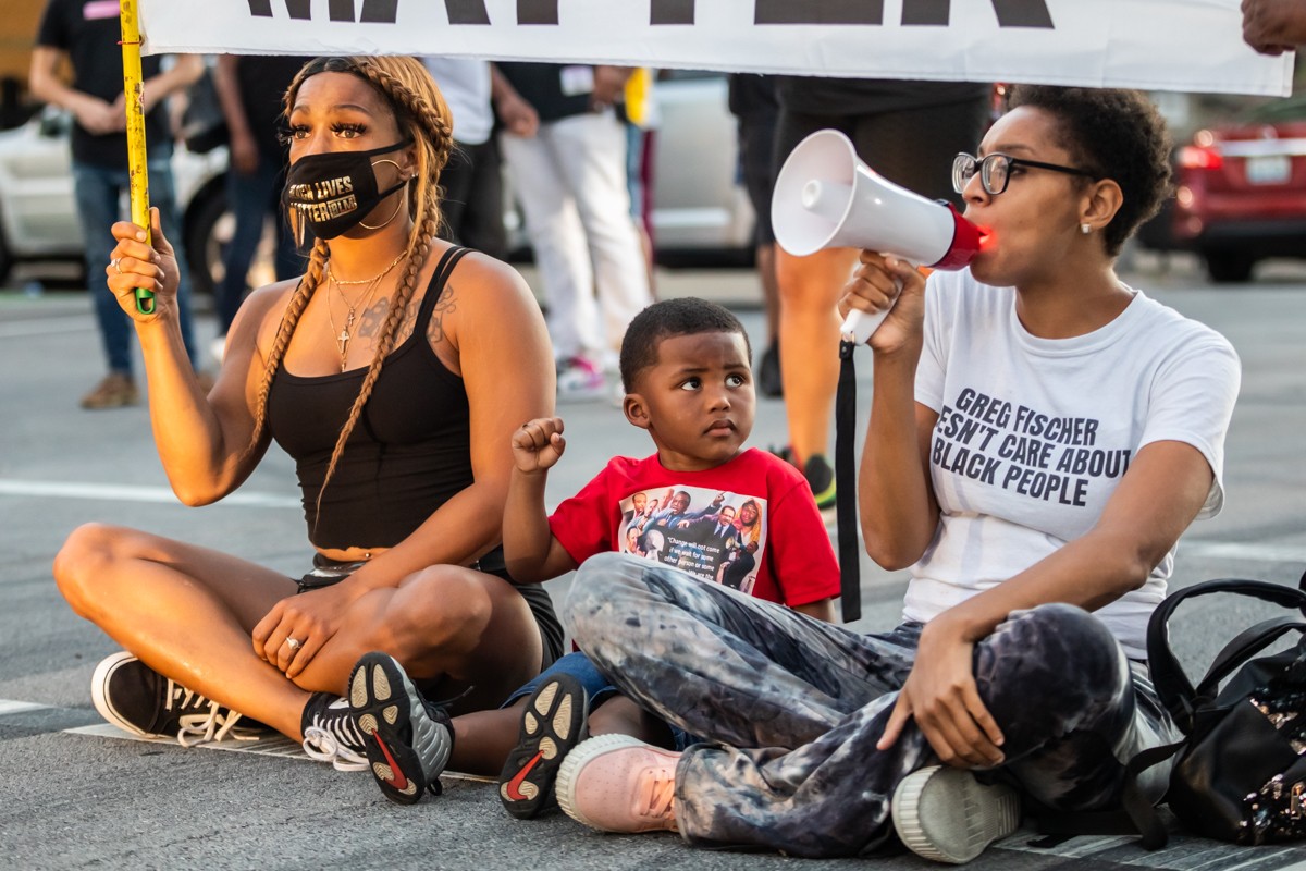 A group of protesters sat in the middle of Jefferson Street near Jefferson Square Park on the 100th day of protests sparked by the killing of Breonna Taylor by LMPD in March. - KATHRYN HARRINGTON