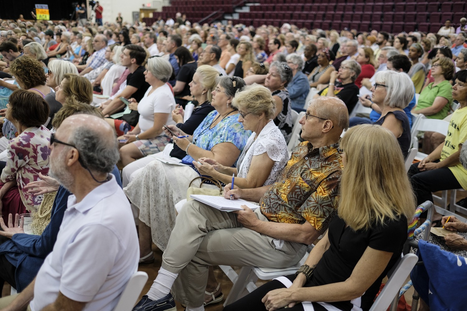Many attendees of the Health Care Town Hall took careful notes while the Congressman spoke about the Affordable Care Act and the Senate's proposal bill. It is estimated that over 700 people were present for the event.