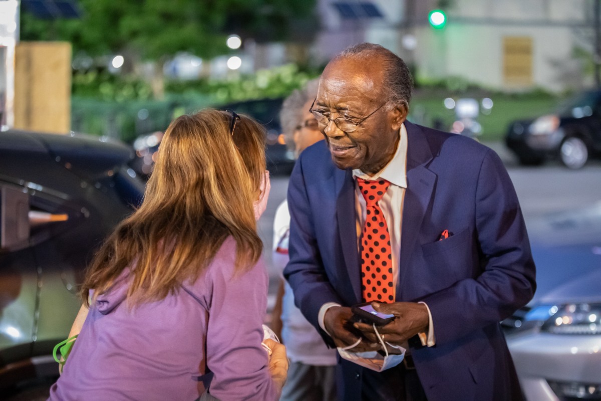 Rev. Dr. Charles Elliott Jr. spoke to a volunteer who was handing out masks in Jefferson Square Park on Friday. - KATHRYN HARRINGTON
