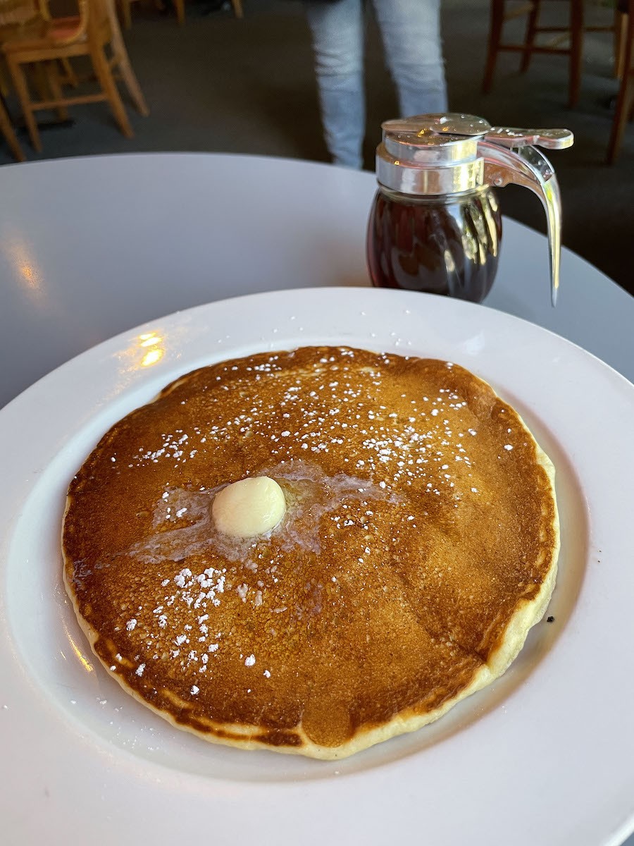 A single, plate-size cornmeal buttermilk pancake with maple syrup made a tasty brunch dessert.