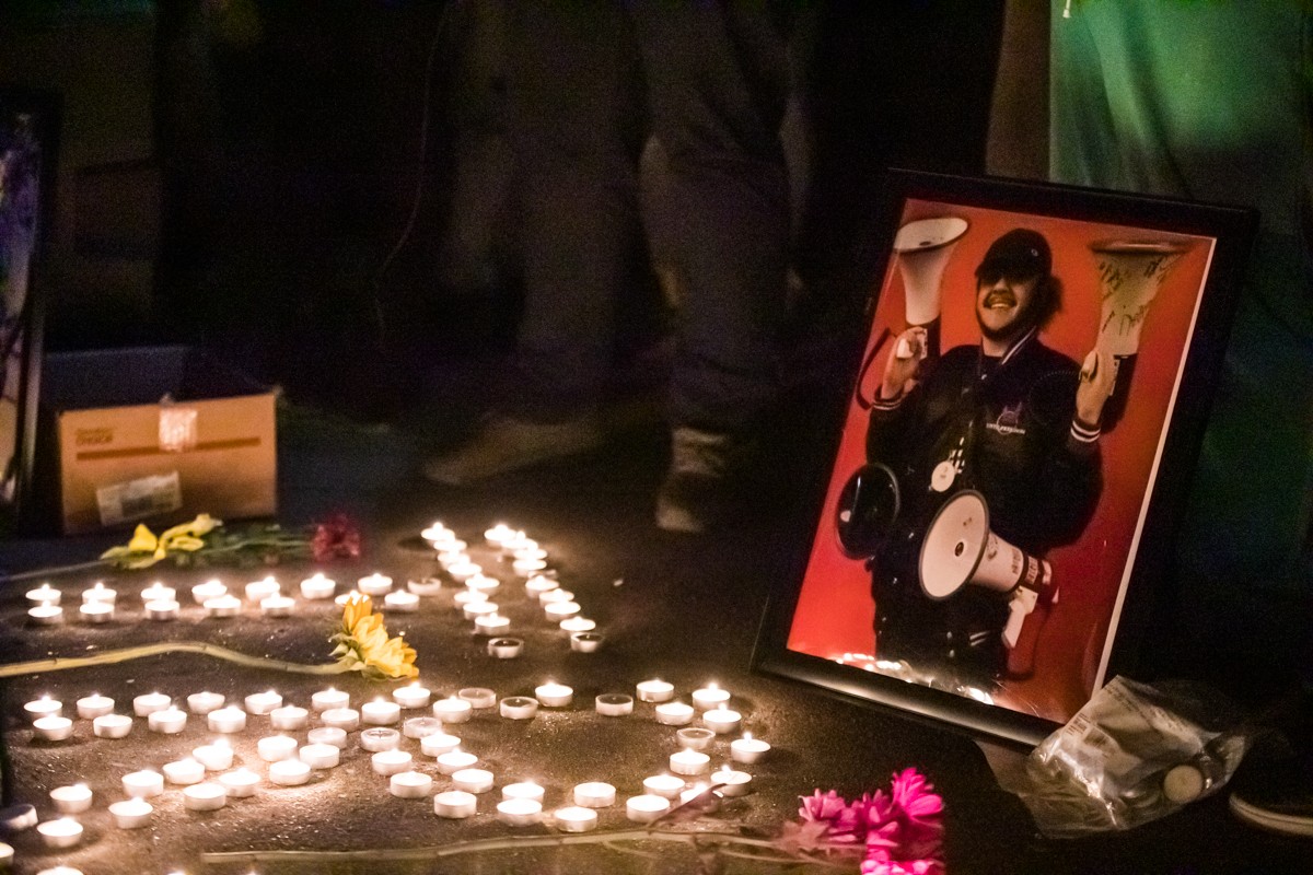 Candles, flowers and photos of Nagdy filled Jefferson Square Park on Monday night. - KATHRYN HARRINGTON