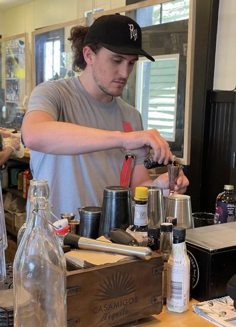 Harrison Wells, bartender at Cultured &#150; Cheese and Charcuterie Bar on East Main Street, fashions a simple but impressive mocktail with Modica mixers.