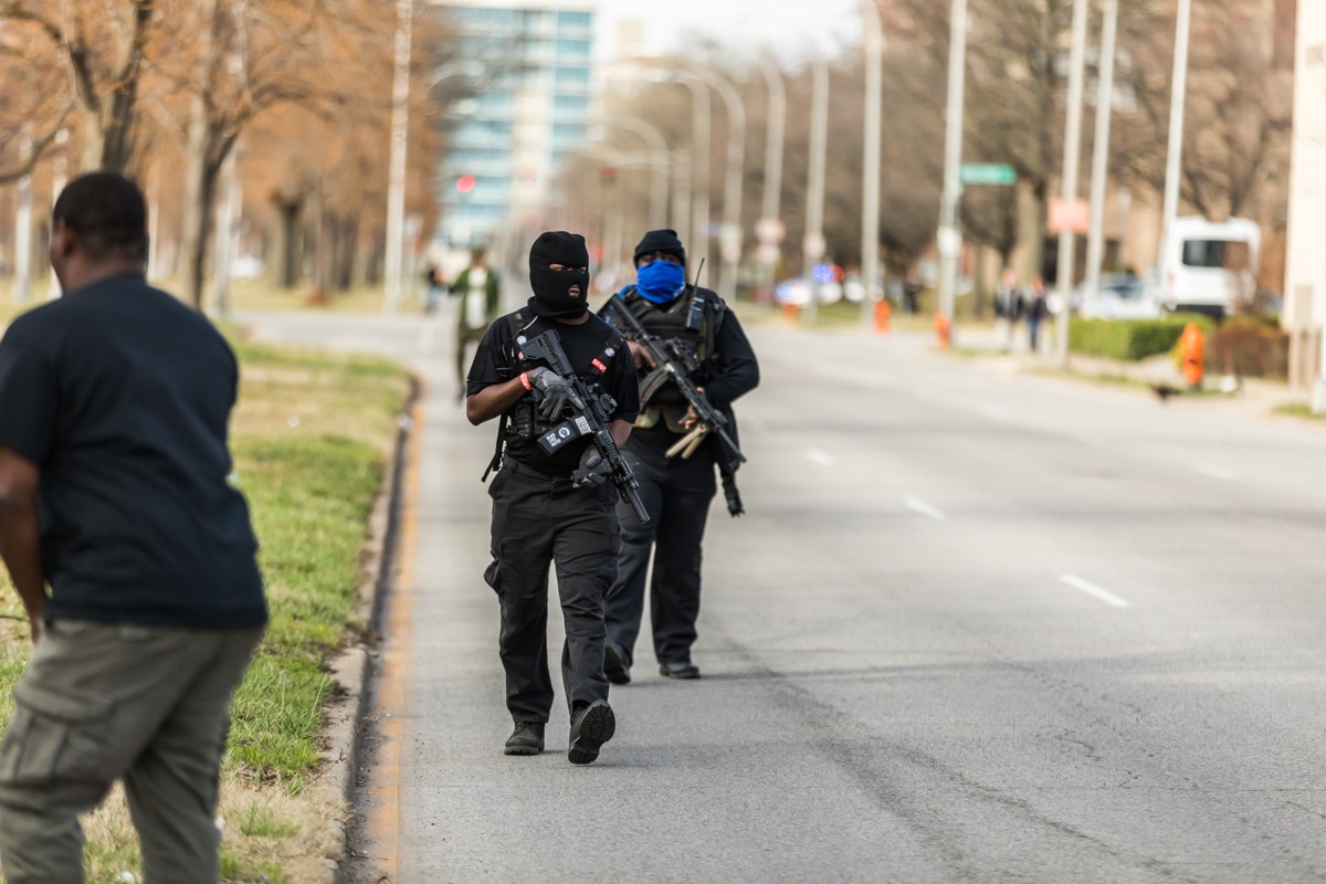 Several armed protesters accompanied the marchers as they went through downtown. - KATHRYN HARRINGTON