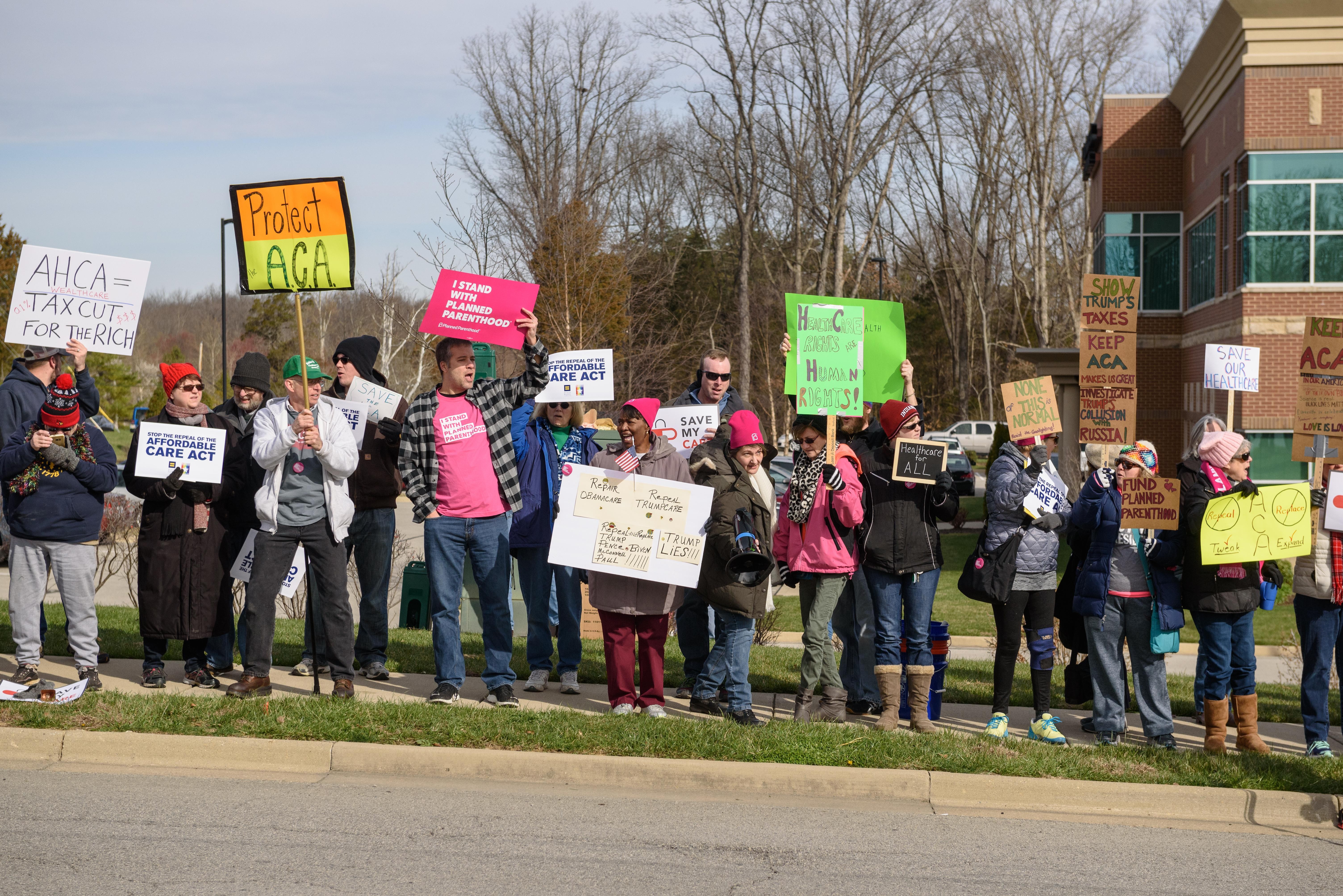 Protesters find their place along Plantside Drive for the arival of Vice President Pence. - BRIAN BOHANNON