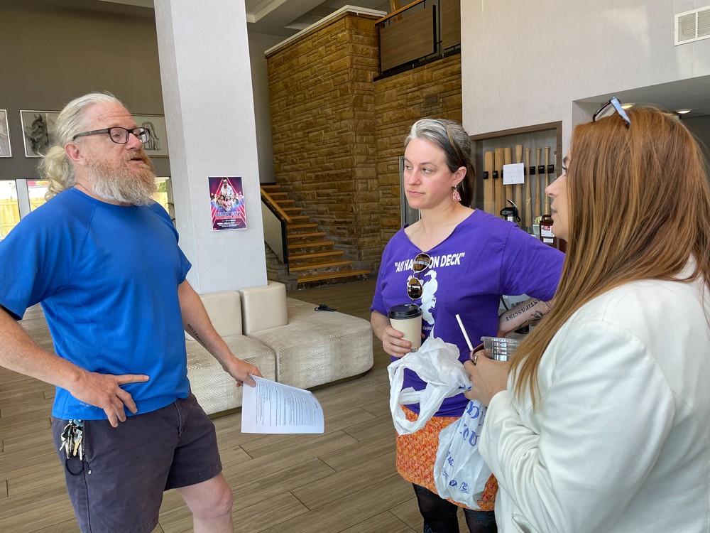 From the left, outreach director and co-founder Donny Greene, assistant outreach director Camila Jasis-Greene, and executive director and co-founder Rhona Bowles Kamar plan the day at Feed Louisville's transitional hotel on Arthur Avenue.