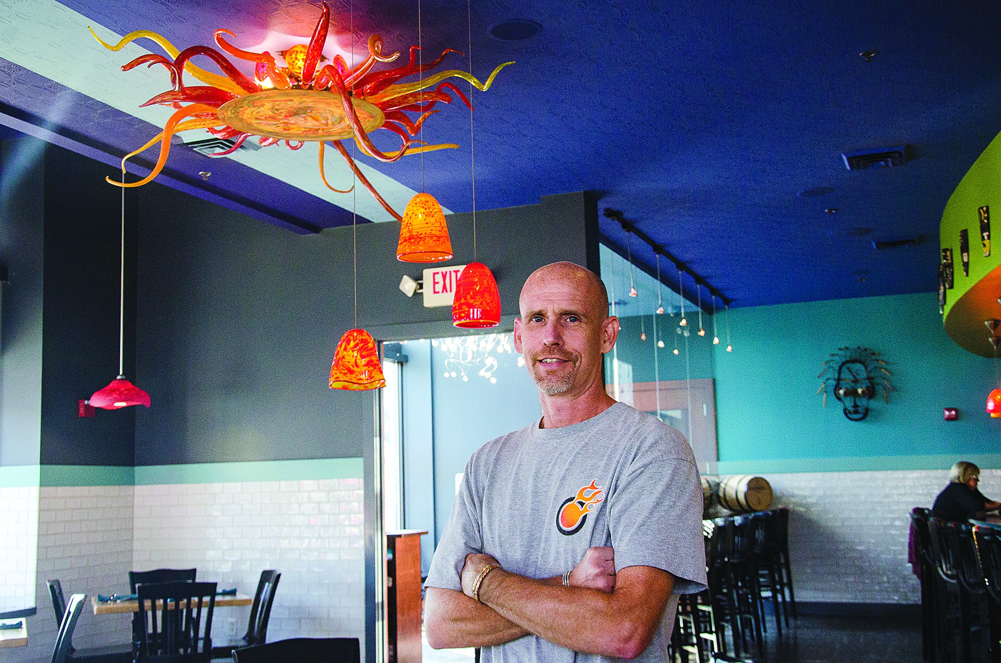 At Wild Rita&#146;s Modern Mexican & Tequila Bar downtown, Brook White of Flame Run stands beneath the blown-glass lights. - photo by Nik Vechery