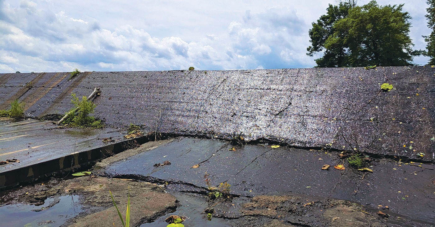 This 95-year-old earthen dam, deteriorating and seeping water, holds back the Loch Mary Reservoir.