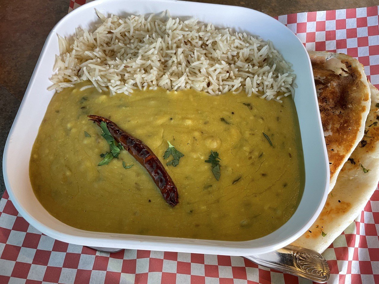 Dal Tadka is a classic Indian dish of yellow lentils and veggies simmered to a comforting porridge, with a spicy tadka mix of spices, chiles and oil stirred in to finish.