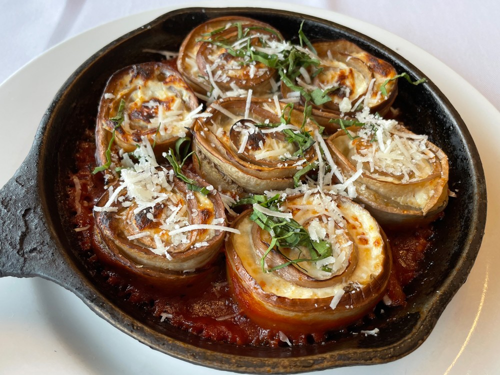 Deeply flavored strips of eggplant form whirls around creamy ricotta in this tasty and filling baked eggplant involtini appetizer.