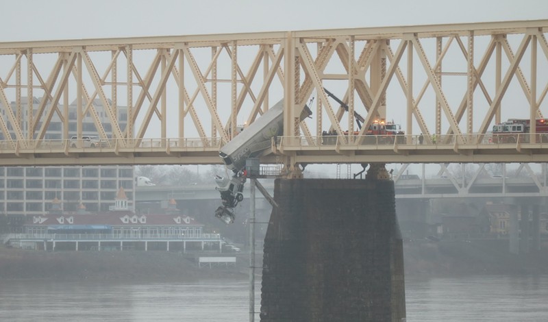 Semi dangles over Louisville's Second Street bridge. - Nick Johnson