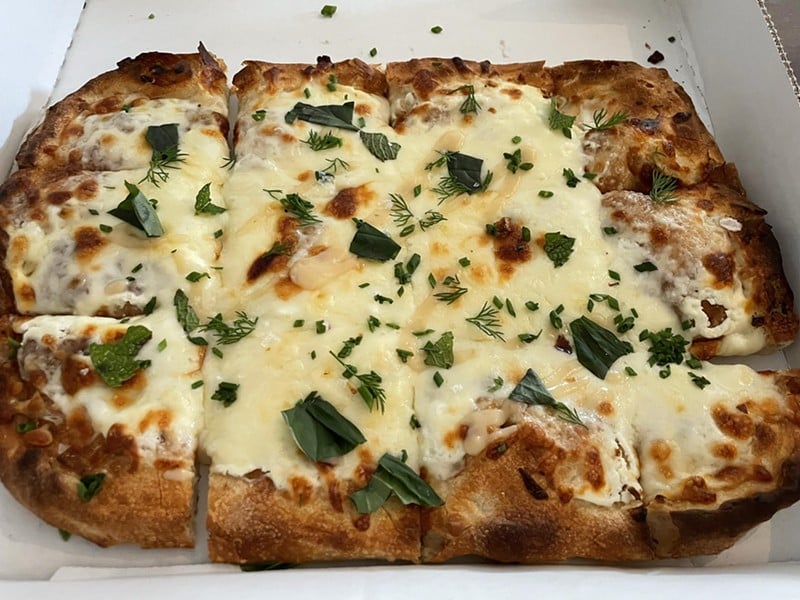 A Roman-style formaggio pizza features three cheeses, garlic cream and herbs on an exceptional hand-thrown, squarish artisanal-bread base. - Robin Garr