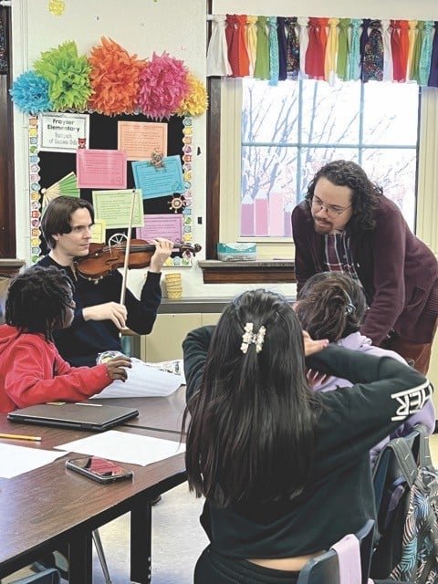 Composer Tyler Taylor (standing) working with students in session of the Young Composers Program held at Frayser Elementary School during the last school year. - Arts Angle Vantage