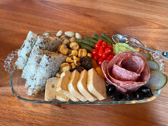 What's a charcuterie plate? This item from Harvey's tells the story: It's an artful display of meat and cheese, a rose-like round of thin-sliced fennel-scented finnochiona salami and a happy contingent of accompaniments.